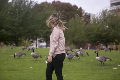 Full length rear view of woman on field