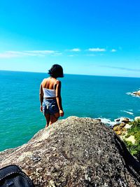 Rear view of woman looking at sea against sky