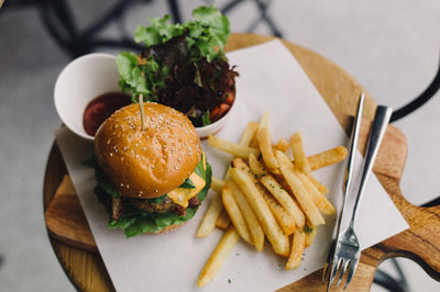 High angle view of hamburger with french fries served in plate at restaurant