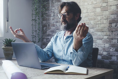 Young man using laptop at office