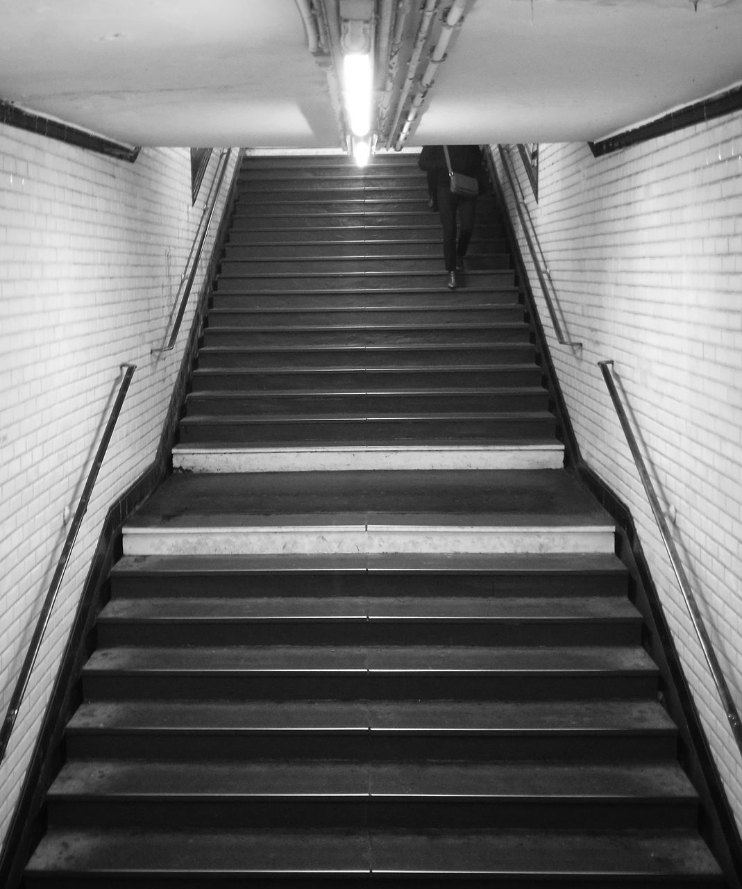 steps and staircases, steps, staircase, illuminated, the way forward, indoors, ceiling, subway, low angle view, architecture, railing, built structure, stairs, no people, hand rail, day