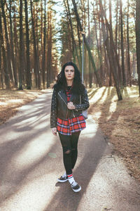 Portrait of young woman standing in forest