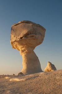 Low angle view of rock formation against clear sky