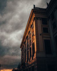 Low angle view of building against cloudy sky