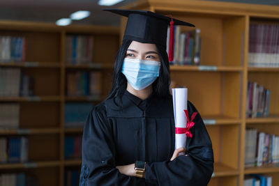 Portrait of young woman reading book