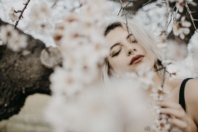 Portrait of a beautiful young woman with eyes closed