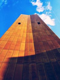 Low angle view of modern building against blue sky