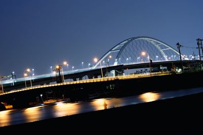 Illuminated bridge at night