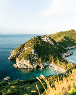 Aerial view of sea and cliff against sky