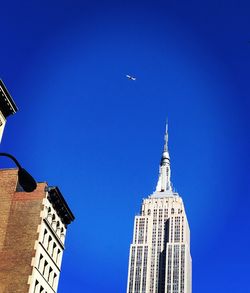 Low angle view of buildings against blue sky