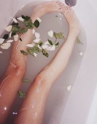 Low section of woman in bathtub