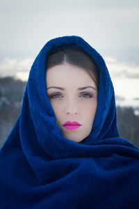 Portrait of beautiful woman covered with head scarf outdoors