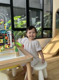 Portrait of boy sitting on table