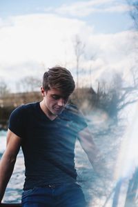 Thoughtful young man standing outdoors