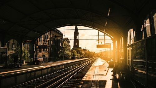 Railway tracks in city against sky