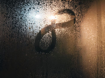 Close-up of wet glass door