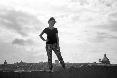 Woman standing on field against sky