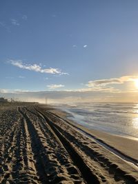 Scenic view of beach against sky during sunset