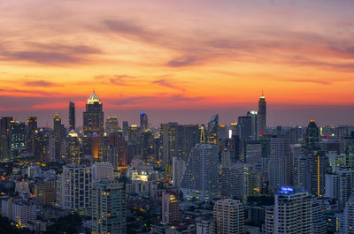 Aerial view of buildings in city during sunset