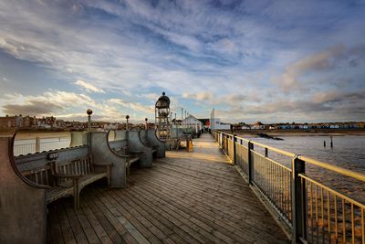 Pier over sea against sky