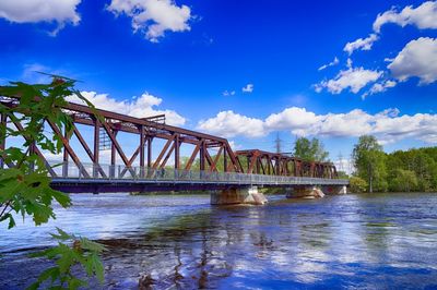 Low angle view of bridge over river against sky