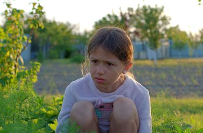 Portrait of girl sitting on field