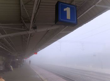 Railroad station platform during foggy weather