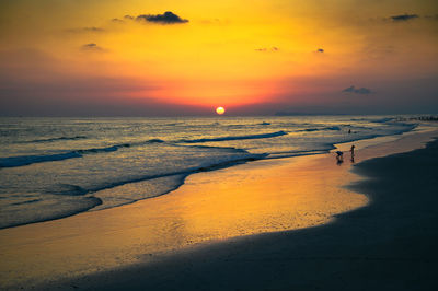 Scenic view of beach against sky during sunset