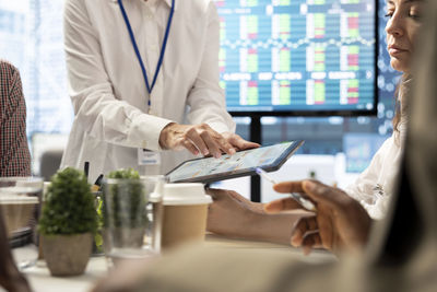 Midsection of doctor working at table