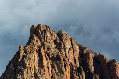 Low angle view of rocky mountains against sky