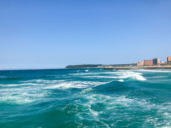 Scenic view of sea against clear blue sky