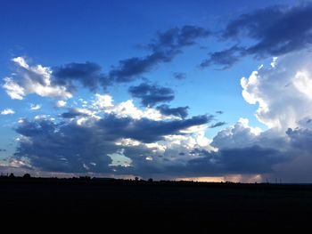 Silhouette landscape against sky