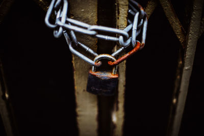 High angle view of rusty chain and padlock on gate