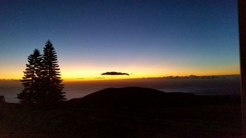 Scenic view of silhouette mountains against sky at sunset