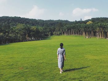 Rear view of man standing on field