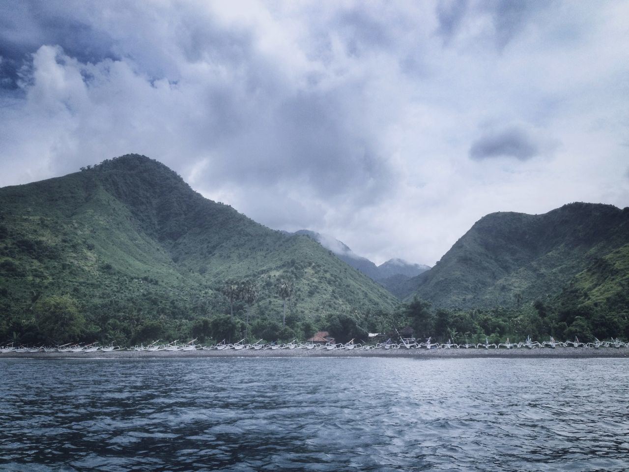 mountain, water, mountain range, sky, scenics, tranquil scene, waterfront, tranquility, beauty in nature, cloud - sky, nature, sea, lake, cloud, cloudy, tree, idyllic, river, day, non-urban scene