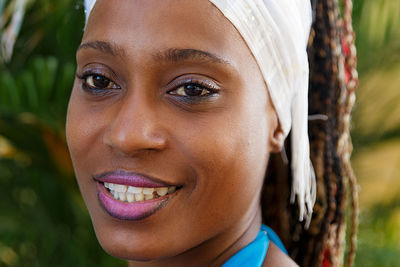 Close-up portrait of smiling woman wearing bandana