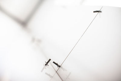 Low angle view of airplane flying against sky