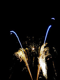 Low angle view of firework display against sky at night