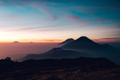 Scenic view of silhouette mountains against sky during sunset