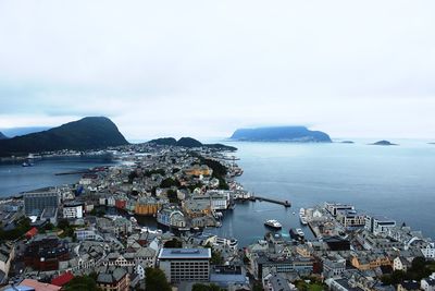 High angle view of alesund by sea against cloudy sky