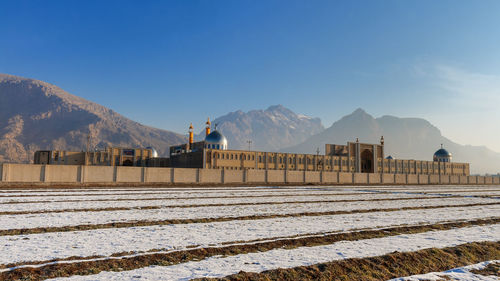 Built structure on snowcapped mountain against sky