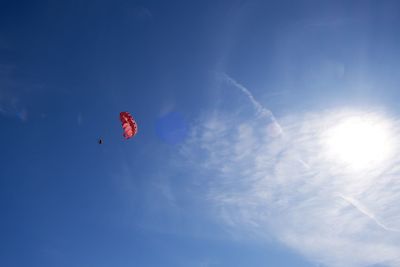 Low angle view of person paragliding against sky