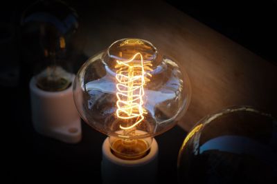 Close-up of light bulb at night