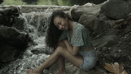 Woman sitting on rock