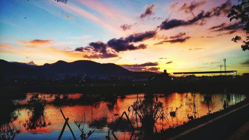 Scenic view of silhouette mountains against sky at sunset