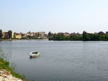 Sailboats in river against clear sky