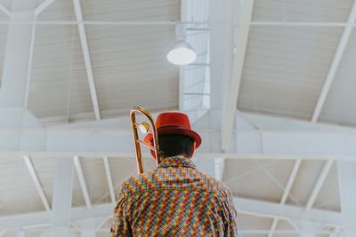 Rear view of woman standing in corridor