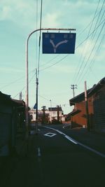 Road by street against sky in city