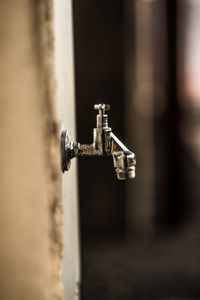 Close-up of faucet against wall